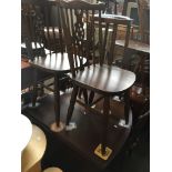 An oak drop leaf table and four wheel back chairs