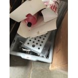 A cutlery box with contents, a shelf and a lipstick remover.