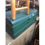 A vintage green metal trunk