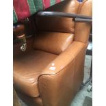 A brown leather wing back armchair