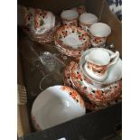 A box of Wellington china dinnerware and some glass