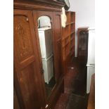 An inlaid oak mirror door wardrobe