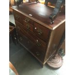 A mahogany chest of drawers with brass handles