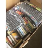 A box of various DVDs and cassettes