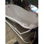 A Mamia baby bath with stand.