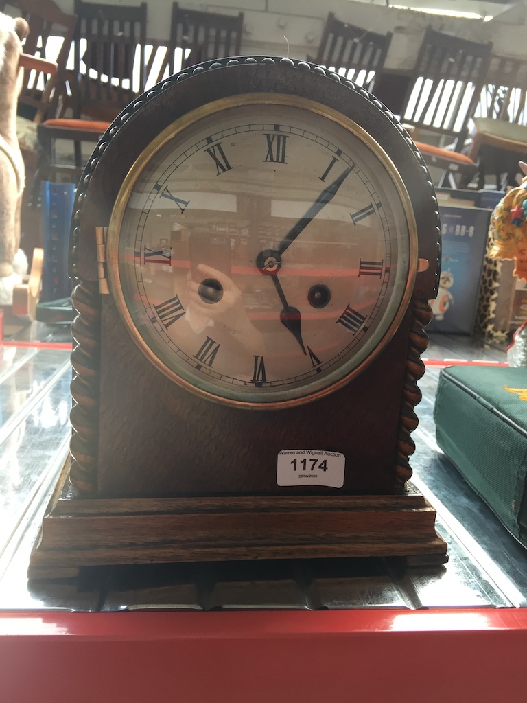 A wooden domed mantel clock.