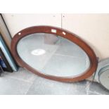 An oval wooden frame mirror. Catalogue only, live bidding available via our website. If you