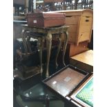 A nest of two gold painted and decorated tables, three trays, and a vintage brown case Catalogue