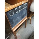 A folding table and a chalk board Catalogue only, live bidding available via our website. If you