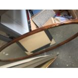 An oval mirror Catalogue only, live bidding available via our website. If you require P&P please