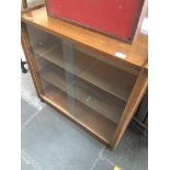 A glass sliding bookcase Catalogue only, live bidding available via our website. If you require P&