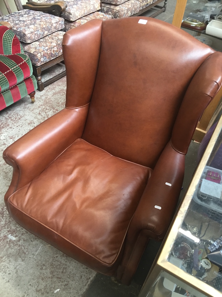 A Laura Ashley leather wing back chair with brass castors Catalogue only, live bidding available via