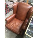 A Laura Ashley leather wing back chair with brass castors Catalogue only, live bidding available via
