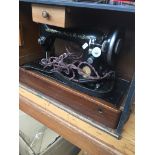 An electric Singer sewing machine, with power lead. Catalogue only, live bidding available via our