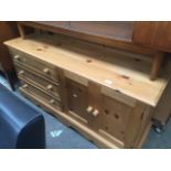 A modern pine low cupboard Catalogue only, live bidding available via our website. If you require