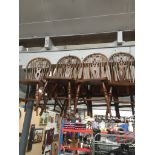 A set of four elm seated wheel back chairs. Catalogue only, live bidding available via our