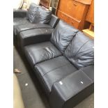 A pair of dark grey leather settees Catalogue only, live bidding available via our website. If you