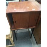 A mid 20th century teak record cabinet on spindle legs Catalogue only, live bidding available via