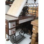 A Singer tressle sewing machine Catalogue only, live bidding available via our website. If you