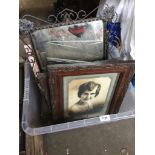 A crate of vintage frames with period photographs.