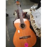 A Malaga acoustic guitar with case. Catalogue only, live bidding available via our website. If you