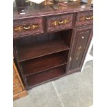 An eastern style carved and brass inlaid side cabinet. Catalogue only, live bidding available via