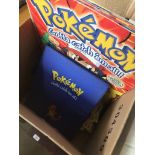 A box containing Pokemon book, cards, etc Catalogue only, live bidding available via our website. If