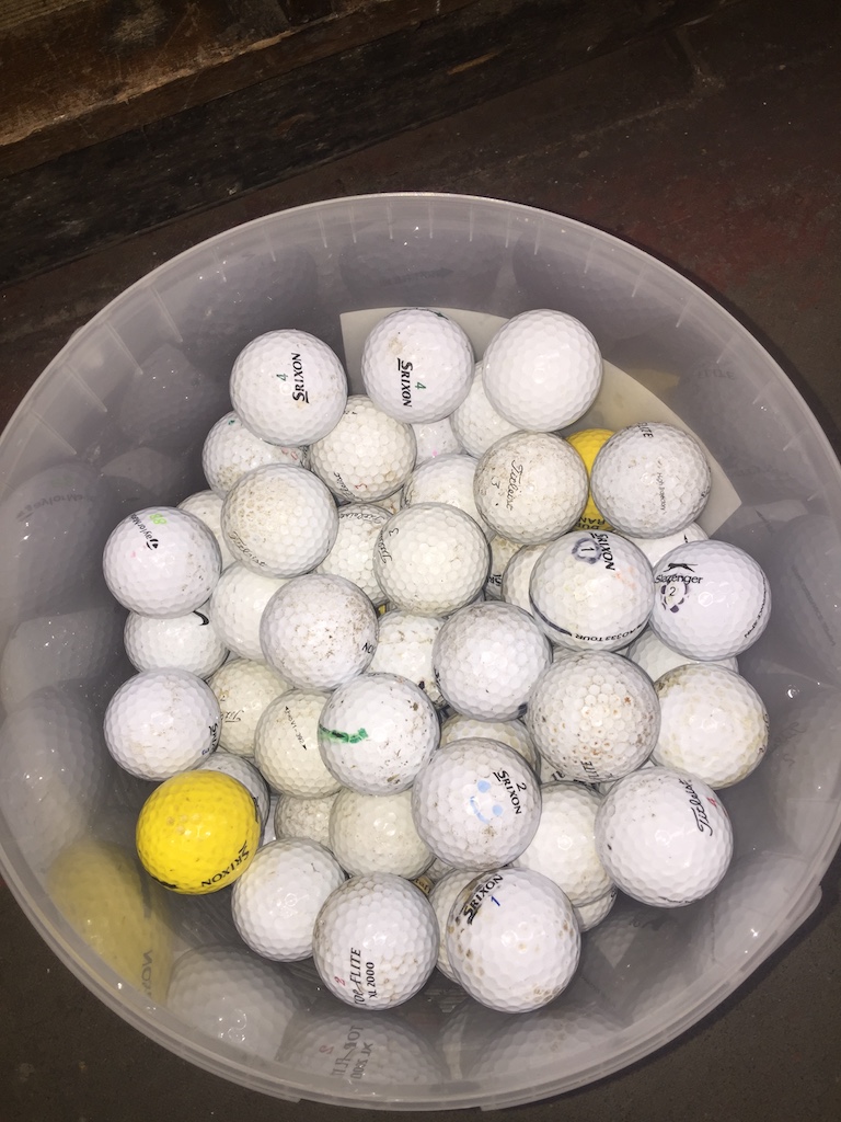 A tub of over 100 golf balls Catalogue only, live bidding available via our website. If you