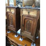 A pair of Continental oak bedside cabinets with carved floral panels and marble tops. Catalogue
