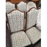A set of four high back dining chairs with upholstery Catalogue only, live bidding available via our