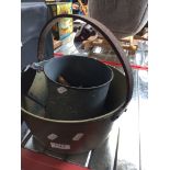 A small brass jam pan and a large tin mug containing pegs