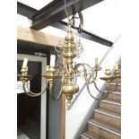 A large brass chandelier. Catalogue only, live bidding available via our website. If you require P&P