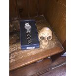 A boxed Winner wristwatch and a ceramic skull