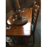 A good quality reproduction oak refectory dining table with four ladder back chairs having leather