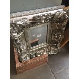 A modern ornate framed mirror Catalogue only, live bidding available via our website. If you require