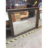 A large ornate framed mirror. 112cm x 141cm Catalogue only, live bidding available via our