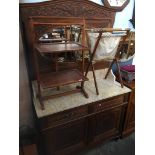 A Continental carved oak mirror back wash stand with carved floral details and beadwork decoration