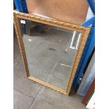 A gilt framed rectangular mirror