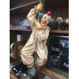 A plaster clown figure on a rope Catalogue only, live bidding available via our website. If you
