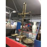 A set of brass weighing scales complete with weights. Catalogue only, live bidding available via our