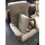 A cream leather adjustable armchair and matching stool Catalogue only, live bidding available via