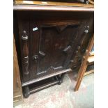 An oak music cabinet with geometric door panel Catalogue only, live bidding available via our