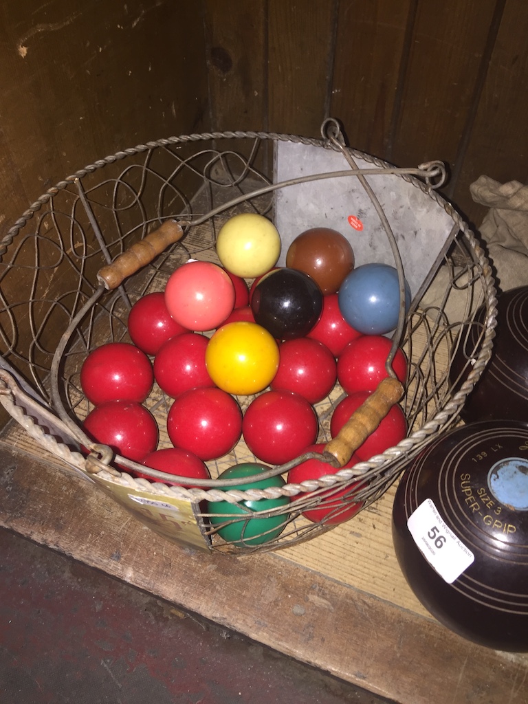 A complete set of snooker balls and wire basket Catalogue only, live bidding available via our