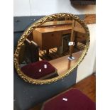 An oval gilded framed mirror Catalogue only, live bidding available via our website. If you