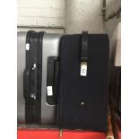A grey hard shell suitcase and another soft case Catalogue only, live bidding available via our