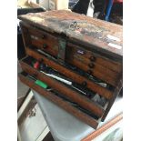 An engineer's wooden multidrawer toolbox with contents. Catalogue only, live bidding available via