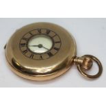 A gold plated half hunter pocket watch in Dennison case, the dial and movement unsigned, case