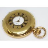 A hallmarked 18ct gold half hunter pocket watch, the white enamel dial having Roman numerals and