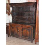 An early 18th century joined oak dresser, the plate rack back constructed with rough sawn panels and