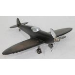 A WWII Spitfire bakelite, aluminium and steel table lighter, wingspan 30cm.